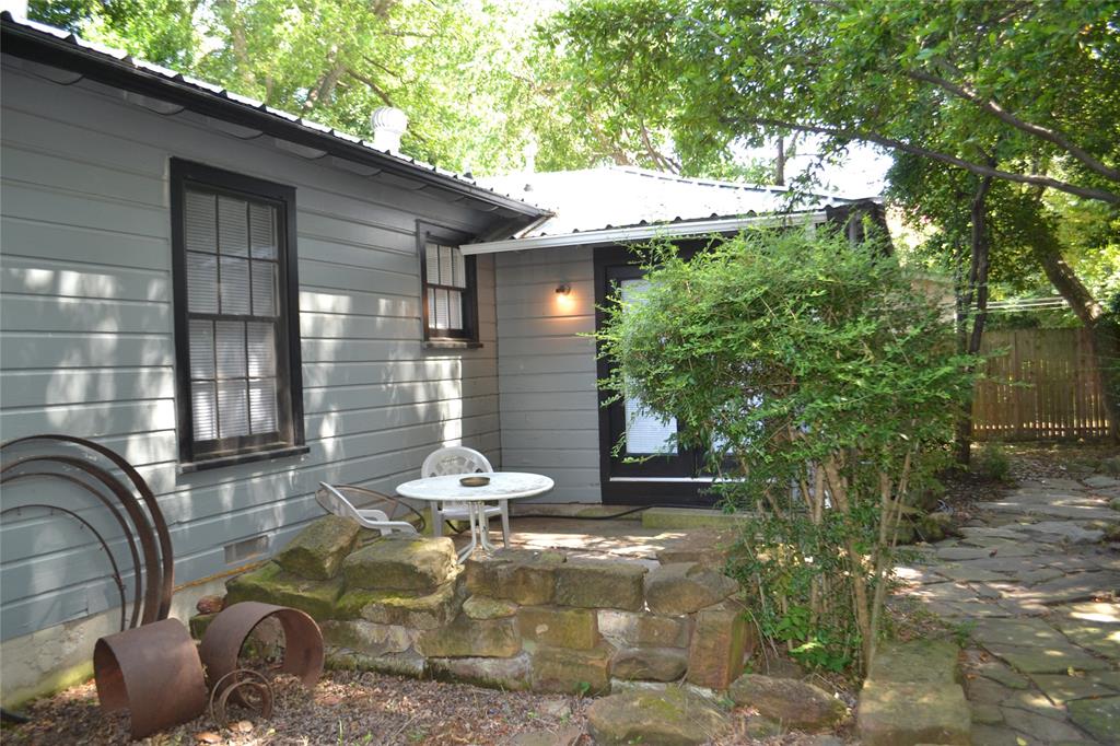 919 Denton Street Denton, TX 76201 - Photo 20 of 23 Rear view of the home showcasing the private, natural setting.