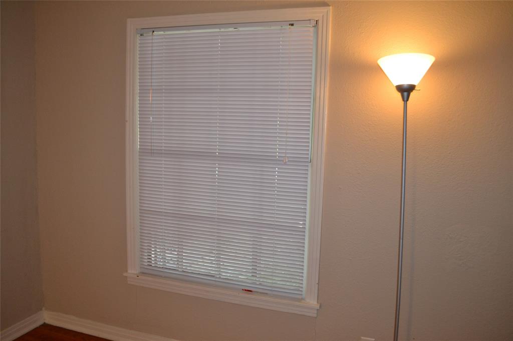 919 Denton Street Denton, TX 76201 - Photo 5 of 23 Bright room with large windows and a classic floor lamp.