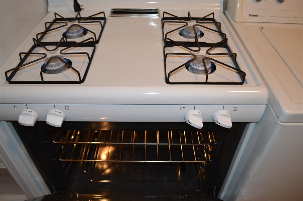 919 Denton Street Denton, TX 76201 - Photo 9 of 23 Modern gas range and oven, ready for home cooking.