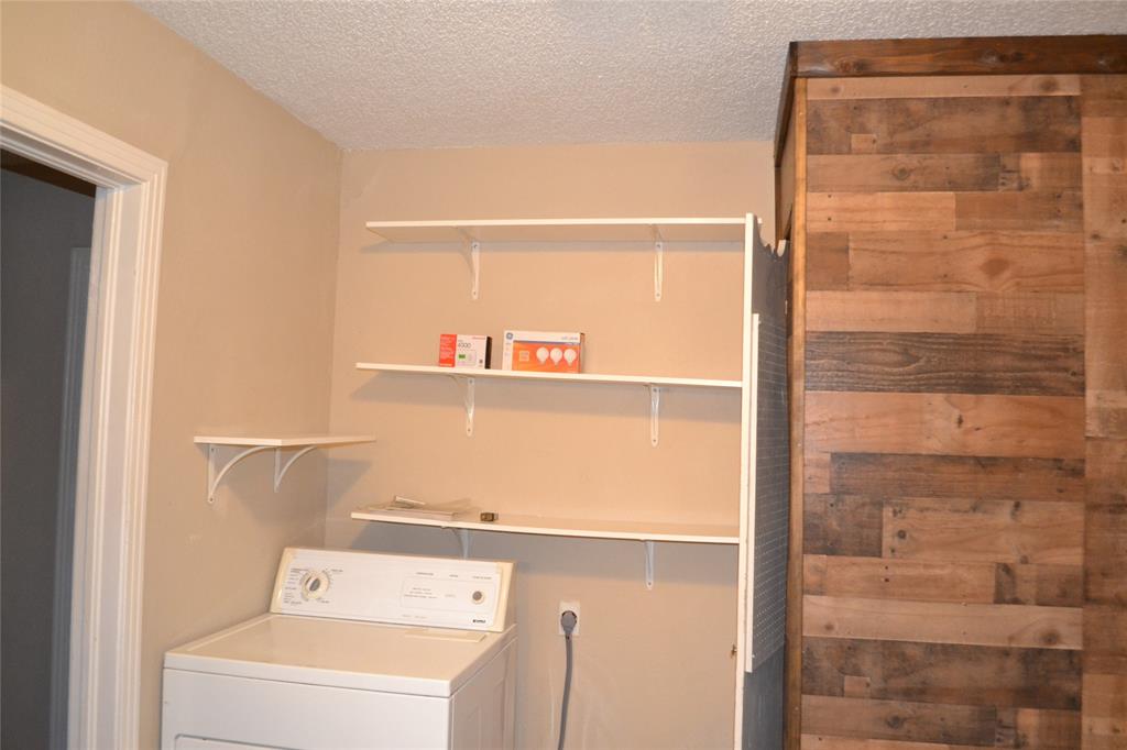 919 Denton Street Denton, TX 76201 - Photo 10 of 23 Laundry area featuring a unique wood-plank accent wall.