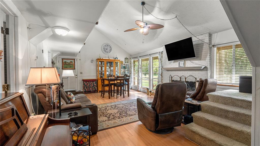 19036 Northwest 246th Street High Springs, FL 32643 - Photo 15 of 30 a living room with furniture fireplace and flat screen tv