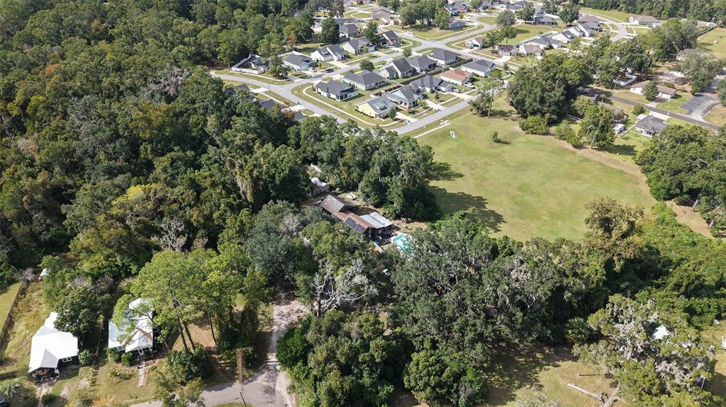 19036 Northwest 246th Street High Springs, FL 32643 - Photo 26 of 30 an aerial view of residential house with outdoor space and trees all around