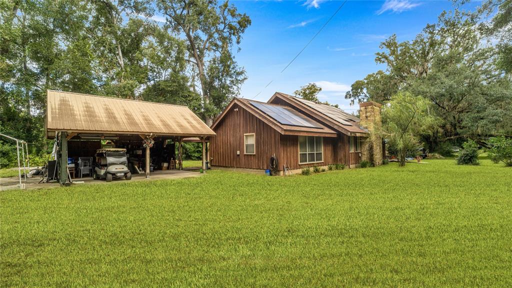 19036 Northwest 246th Street High Springs, FL 32643 - Photo 3 of 30 a view of a house with backyard and sitting area