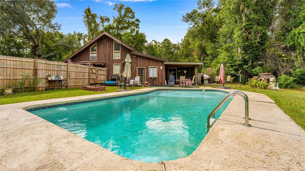 19036 Northwest 246th Street High Springs, FL 32643 - Photo 4 of 30 a view of a house with swimming pool and sitting area