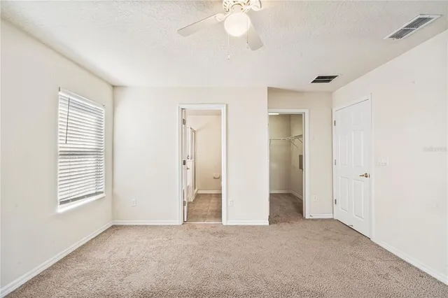 an empty room with windows and closet