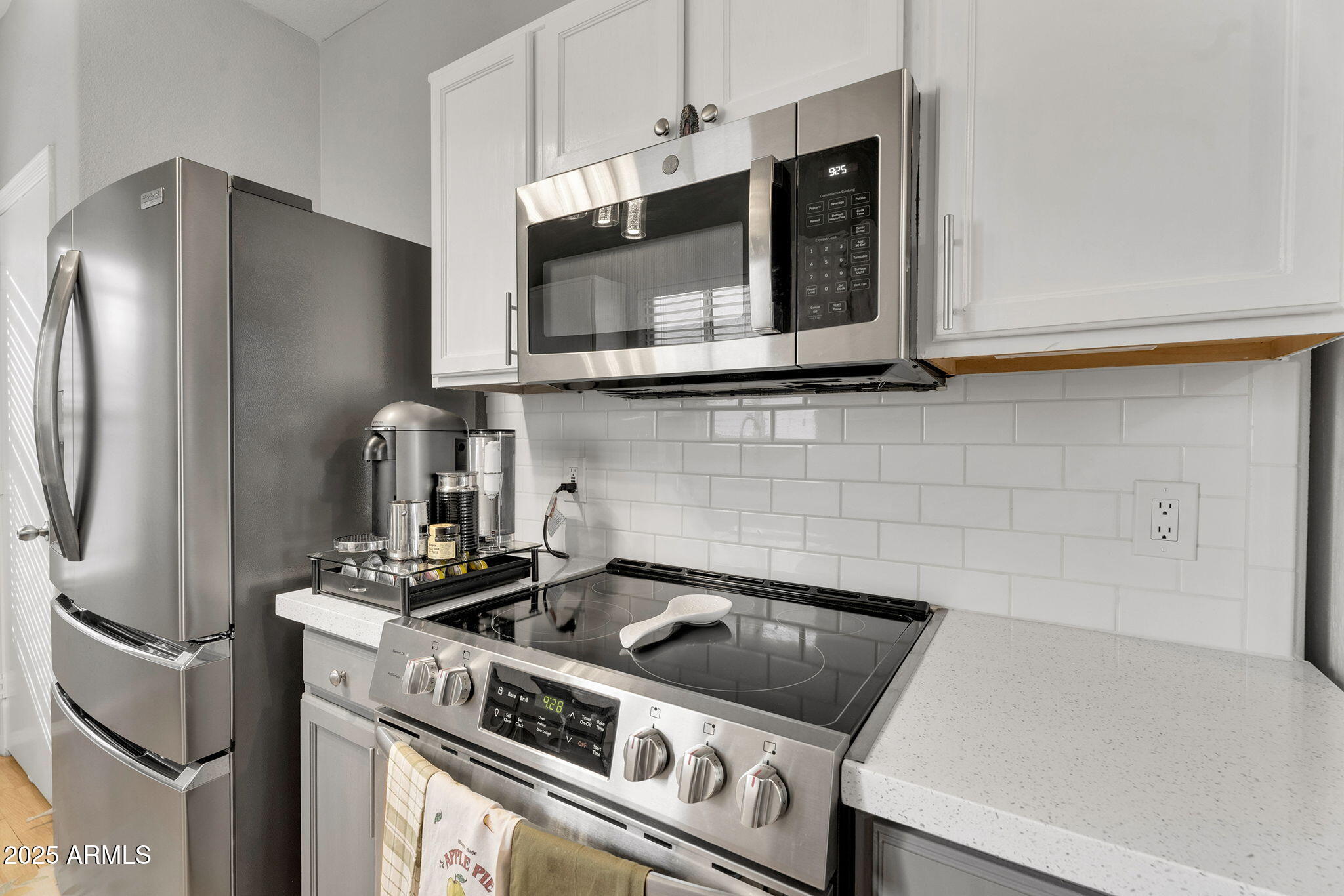 13122 West Calavar Road Surprise, AZ 85379 - Photo 10 of 34 a kitchen with a stove and a microwave