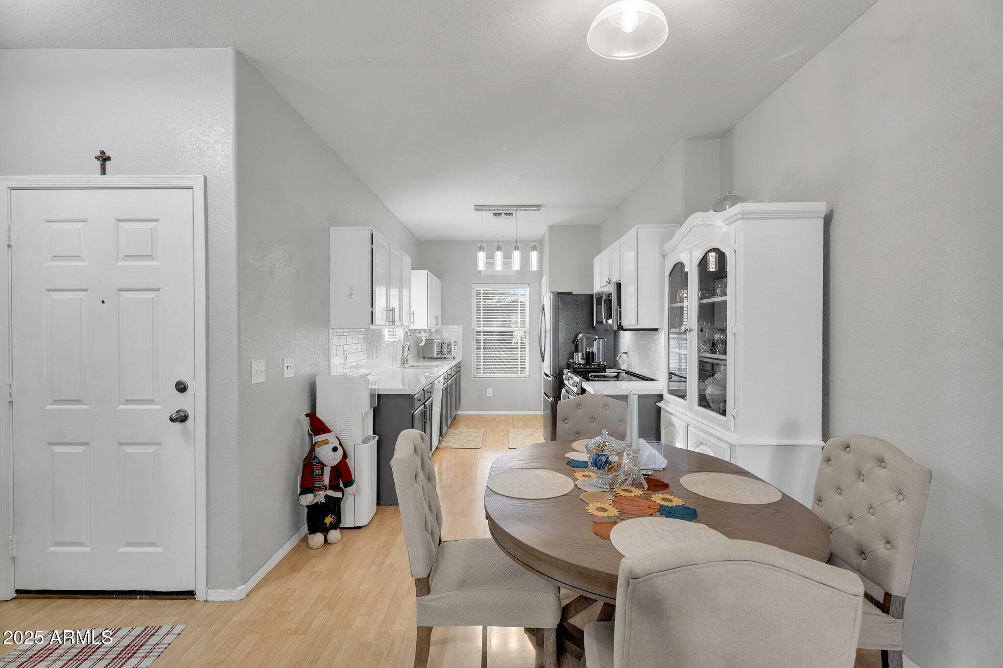 13122 West Calavar Road Surprise, AZ 85379 - Photo 11 of 34 a view of a dining room with furniture and a table