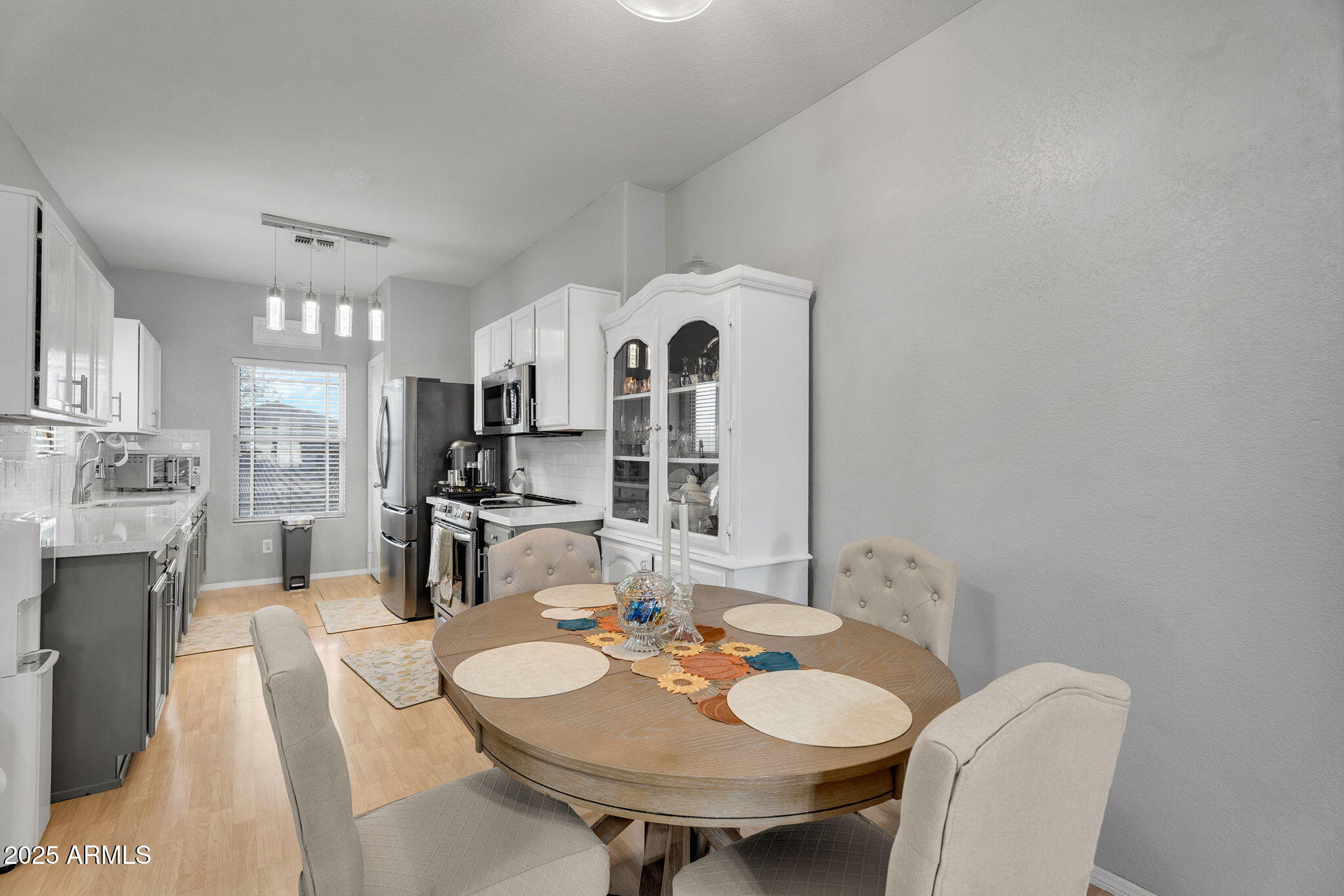 13122 West Calavar Road Surprise, AZ 85379 - Photo 12 of 34 a view of a dining room with furniture and a fireplace