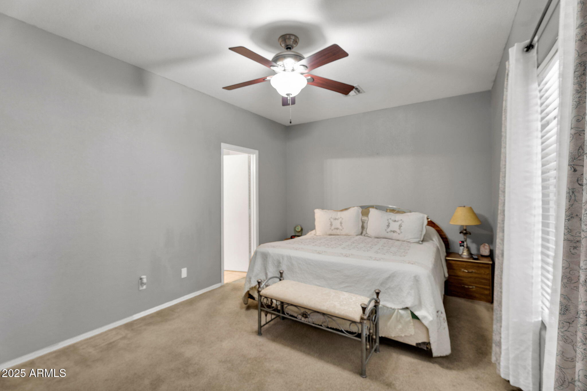 13122 West Calavar Road Surprise, AZ 85379 - Photo 13 of 34 a bedroom with a bed and window