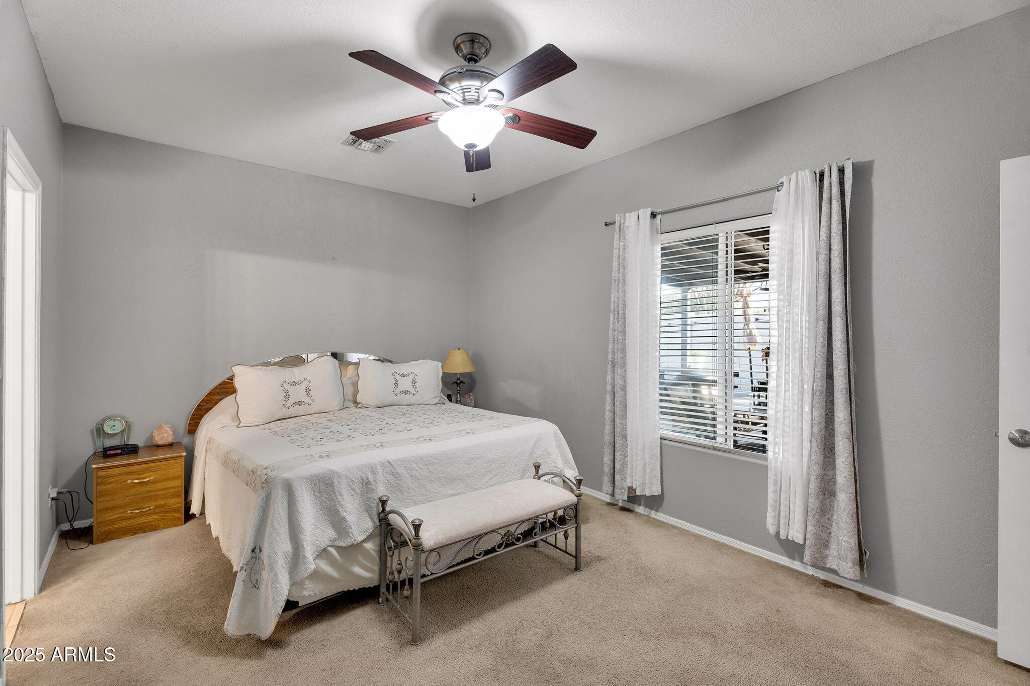 13122 West Calavar Road Surprise, AZ 85379 - Photo 14 of 34 a bedroom with a bed and a chandelier