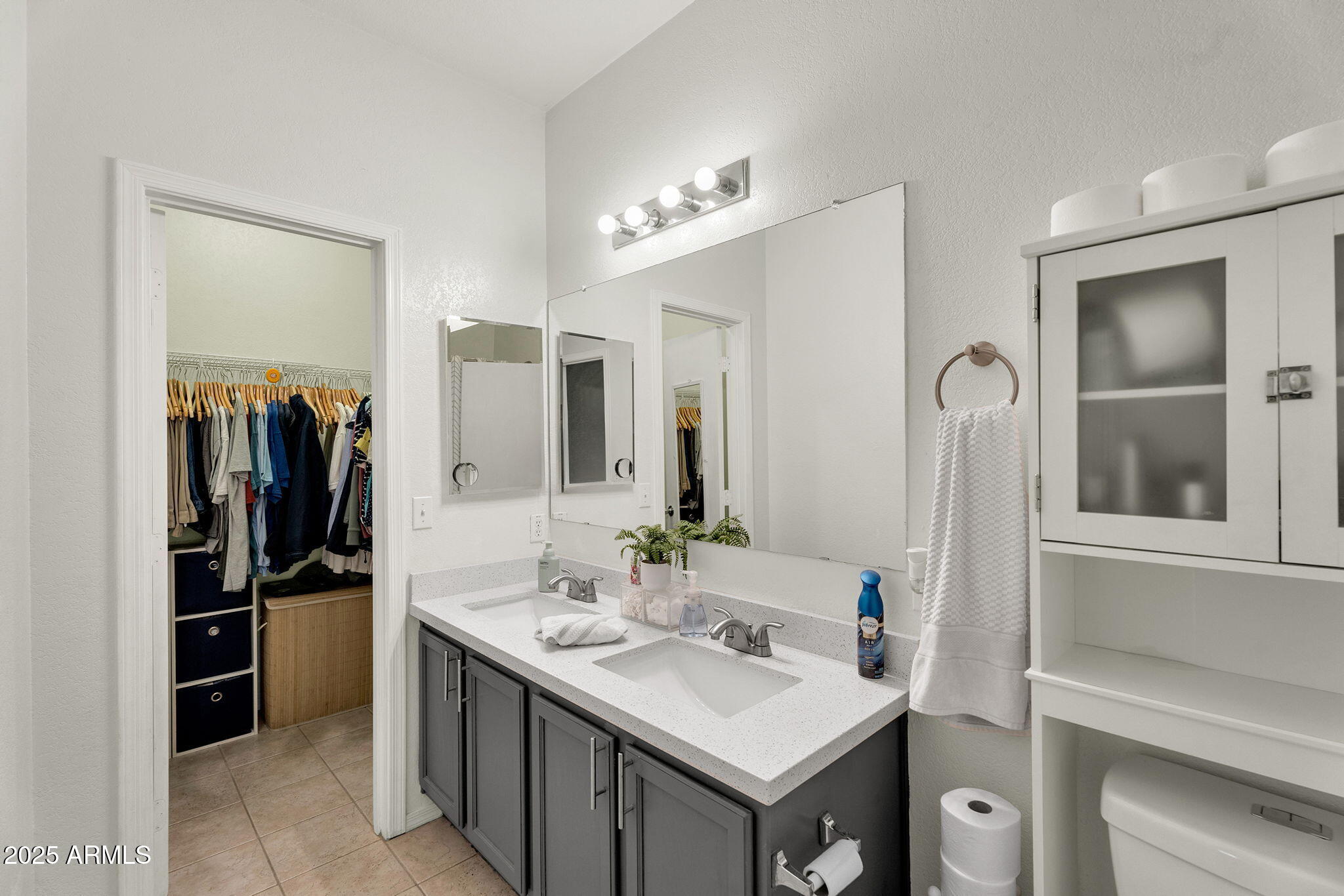13122 West Calavar Road Surprise, AZ 85379 - Photo 18 of 34 a bathroom with a sink vanity and a mirror