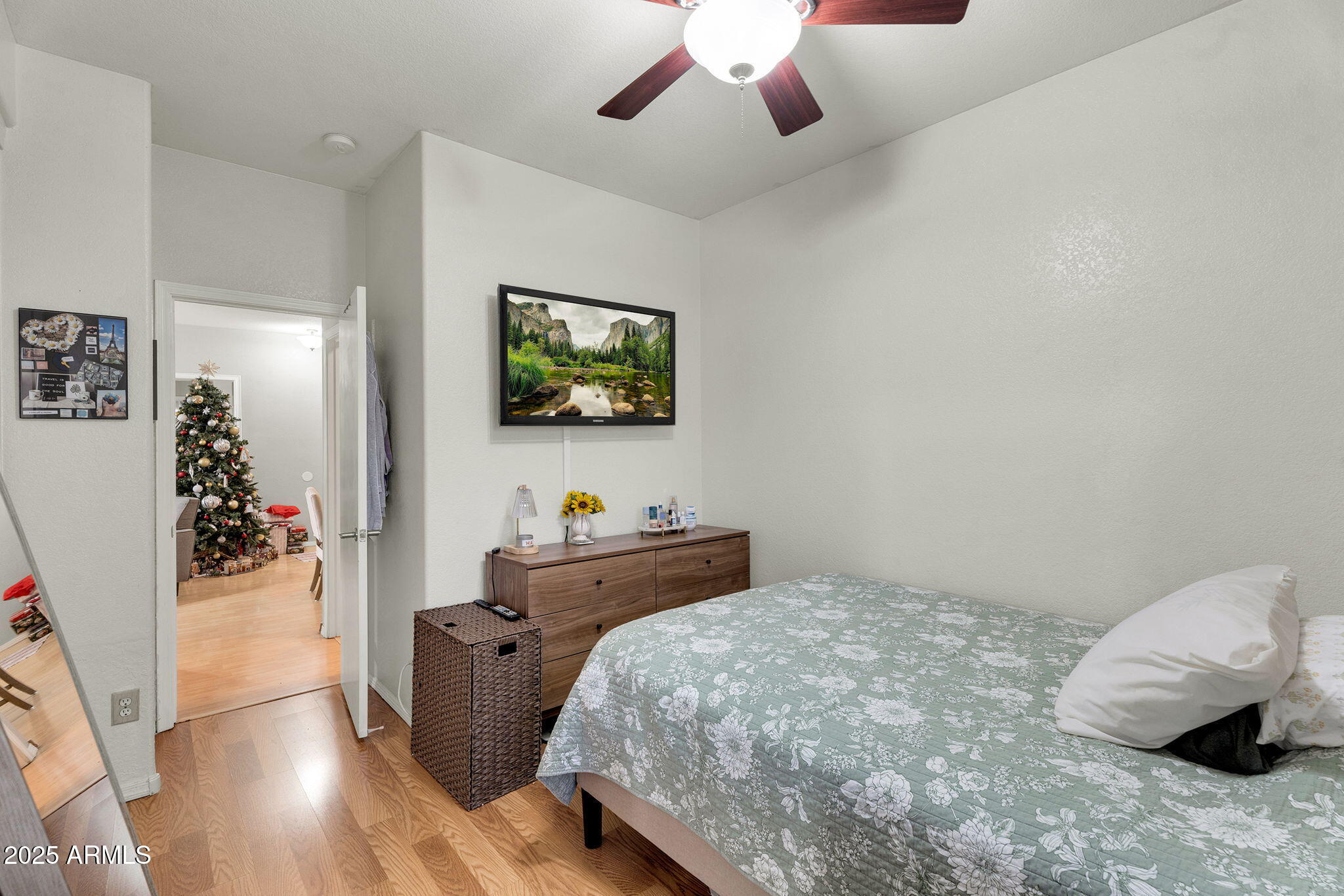 13122 West Calavar Road Surprise, AZ 85379 - Photo 21 of 34 a bedroom with a bed and a flat screen tv