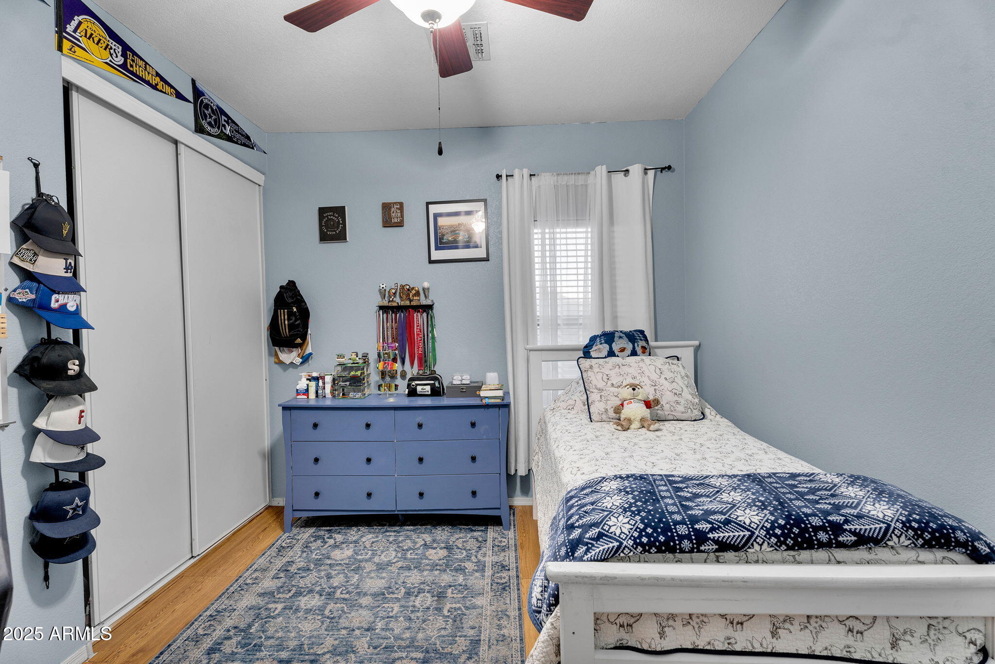 13122 West Calavar Road Surprise, AZ 85379 - Photo 22 of 34 a bedroom with a large bed and a dresser
