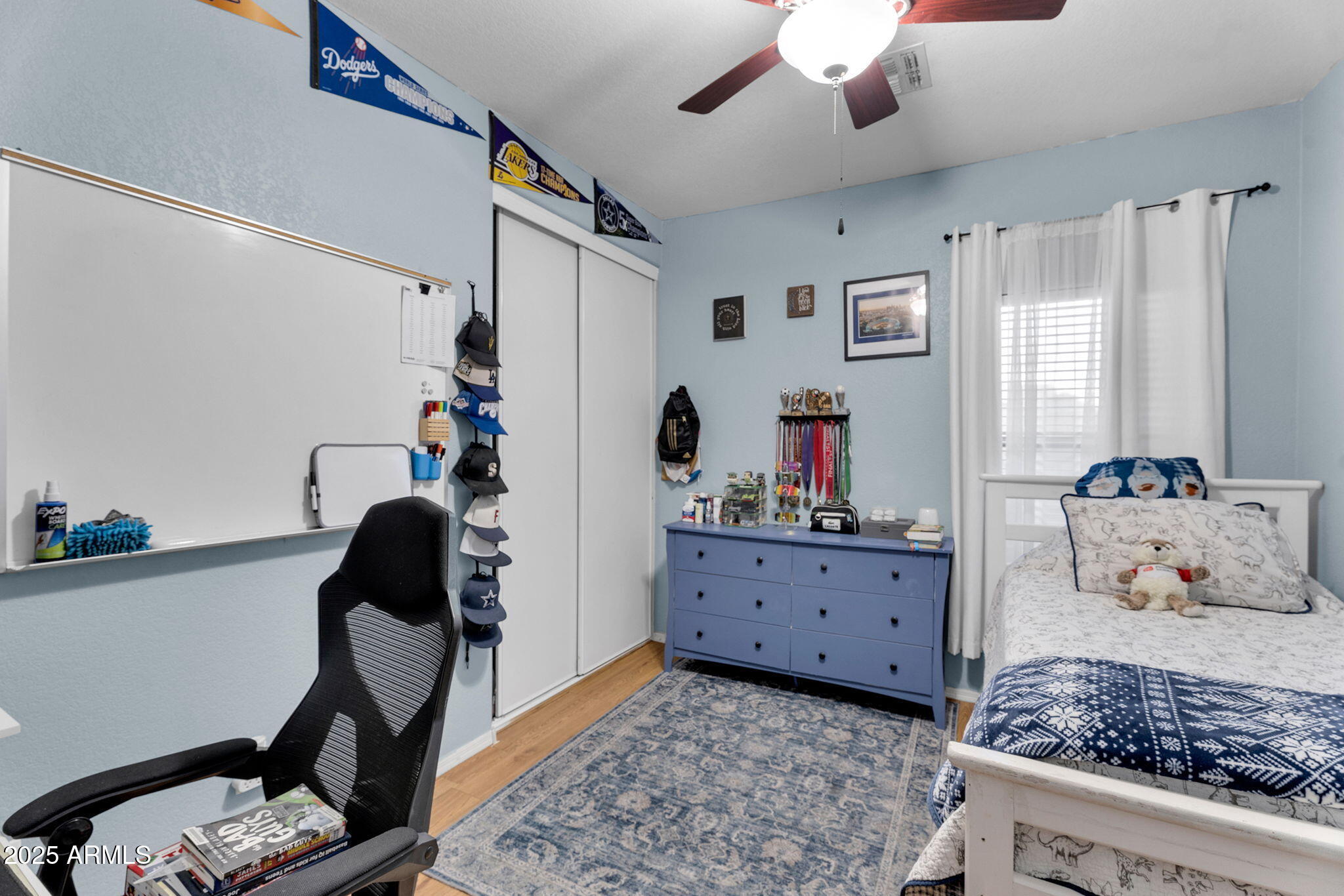 13122 West Calavar Road Surprise, AZ 85379 - Photo 23 of 34 a bedroom with furniture and a dresser
