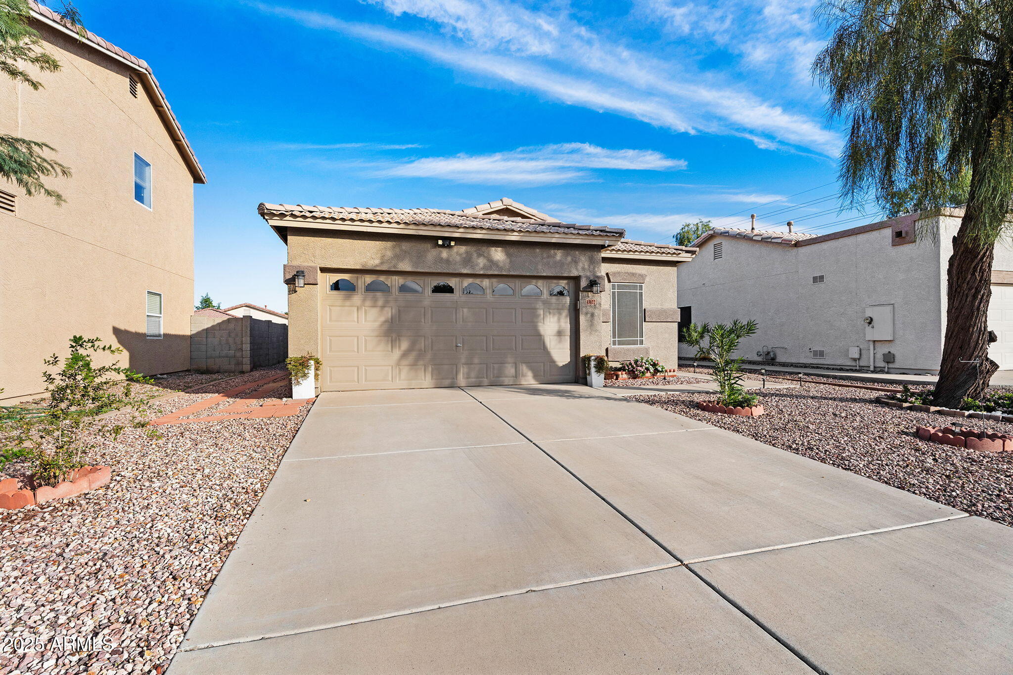 13122 West Calavar Road Surprise, AZ 85379 - Photo 2 of 34 a view of a street with a house