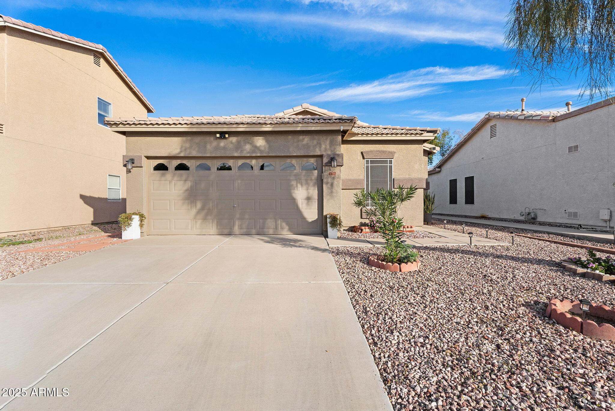 13122 West Calavar Road Surprise, AZ 85379 - Photo 3 of 34 a view of a house with a patio