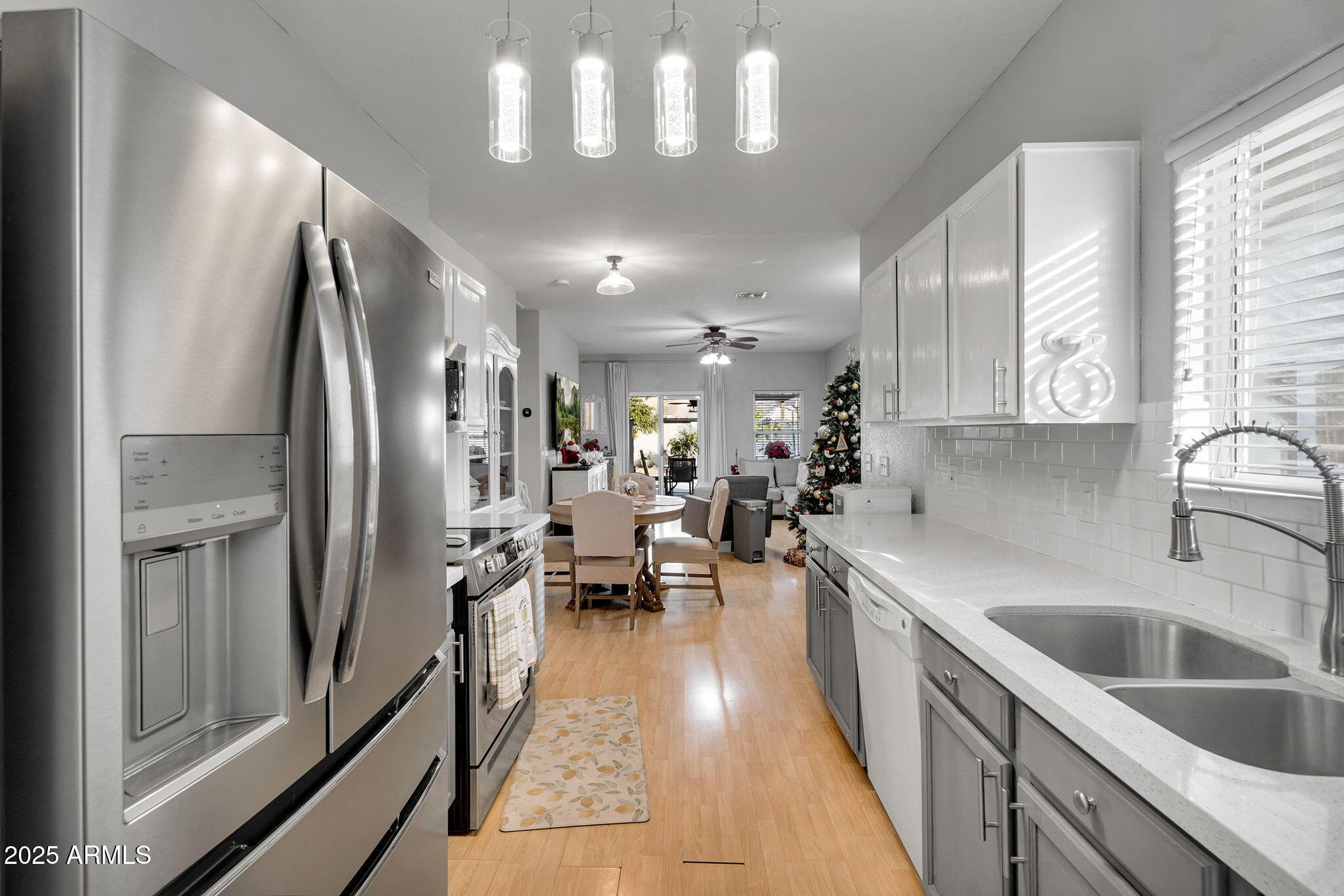 13122 West Calavar Road Surprise, AZ 85379 - Photo 8 of 34 a kitchen with counter top space a sink stainless steel appliances and cabinets