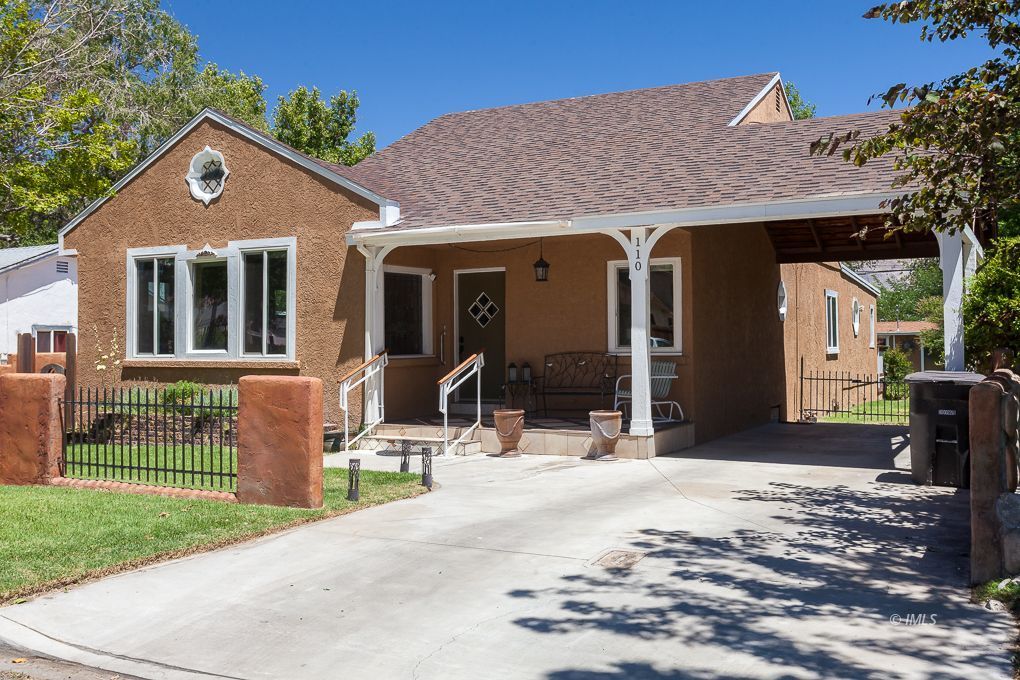110 North Hay Street Lone Pine, CA 93545 - Photo 1 of 23 a front view of a house with a yard outdoor seating and garage