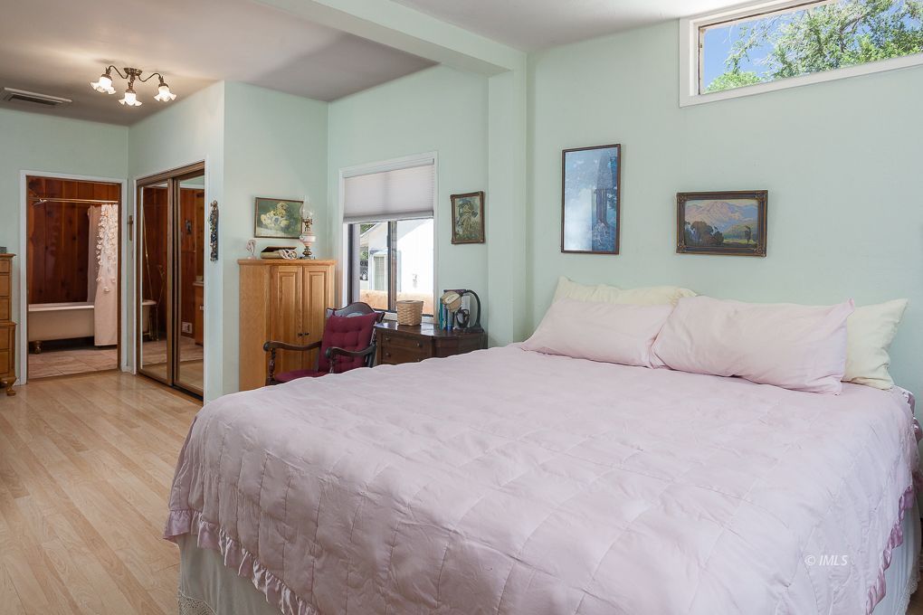 110 North Hay Street Lone Pine, CA 93545 - Photo 15 of 23 a bedroom with a large bed and painting on the wall