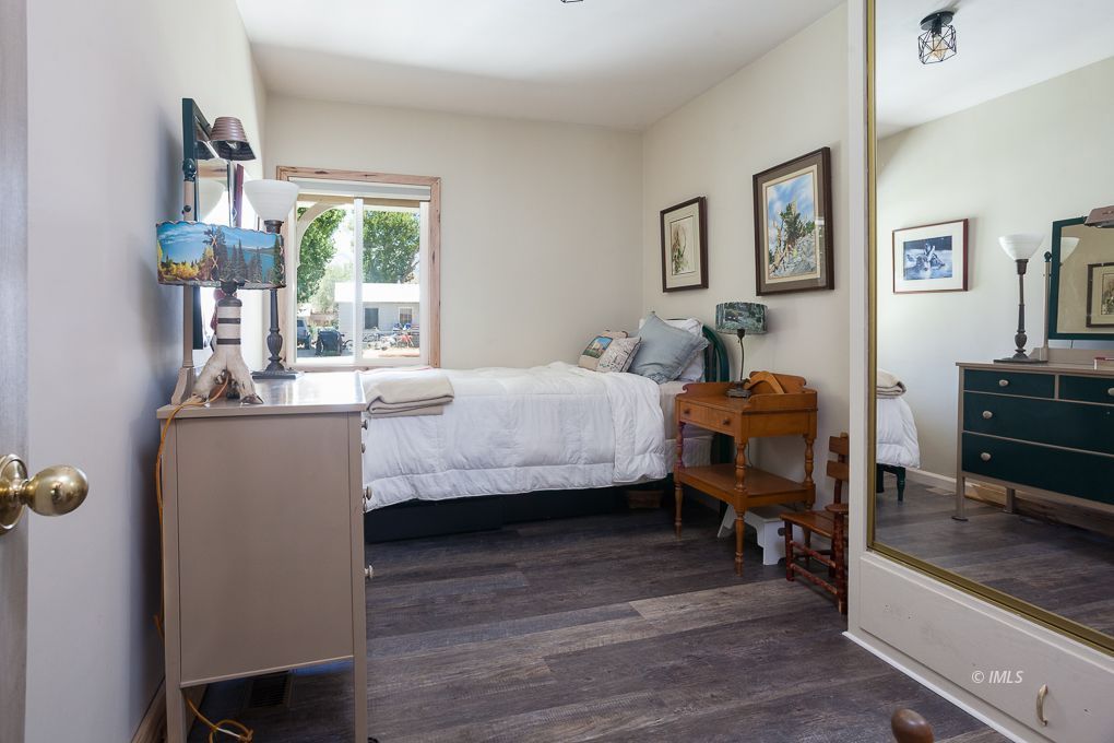 110 North Hay Street Lone Pine, CA 93545 - Photo 19 of 23 a bedroom with a bed a table and painting on the wall