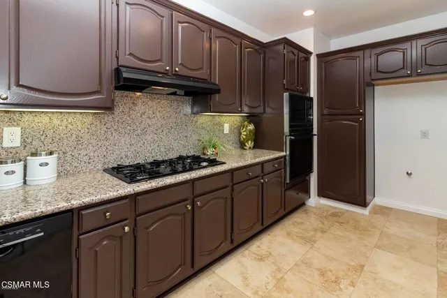 an empty room with windows and fireplace
