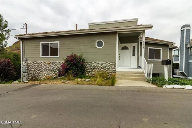 a bathroom with a granite countertop bathtub a sink and a mirror