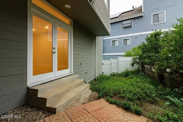 a view of an empty room with wooden floor and closet