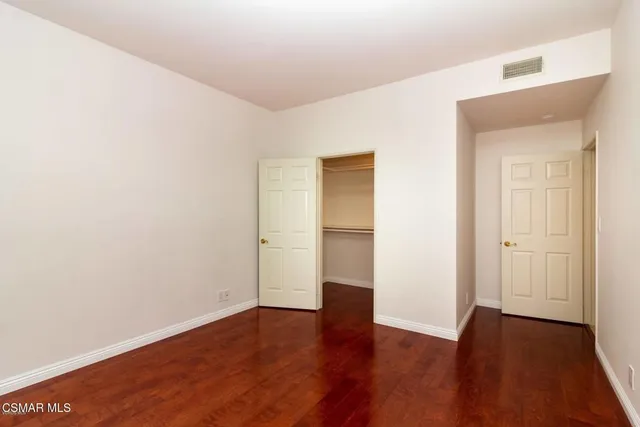 an empty room with closet and a bathroom