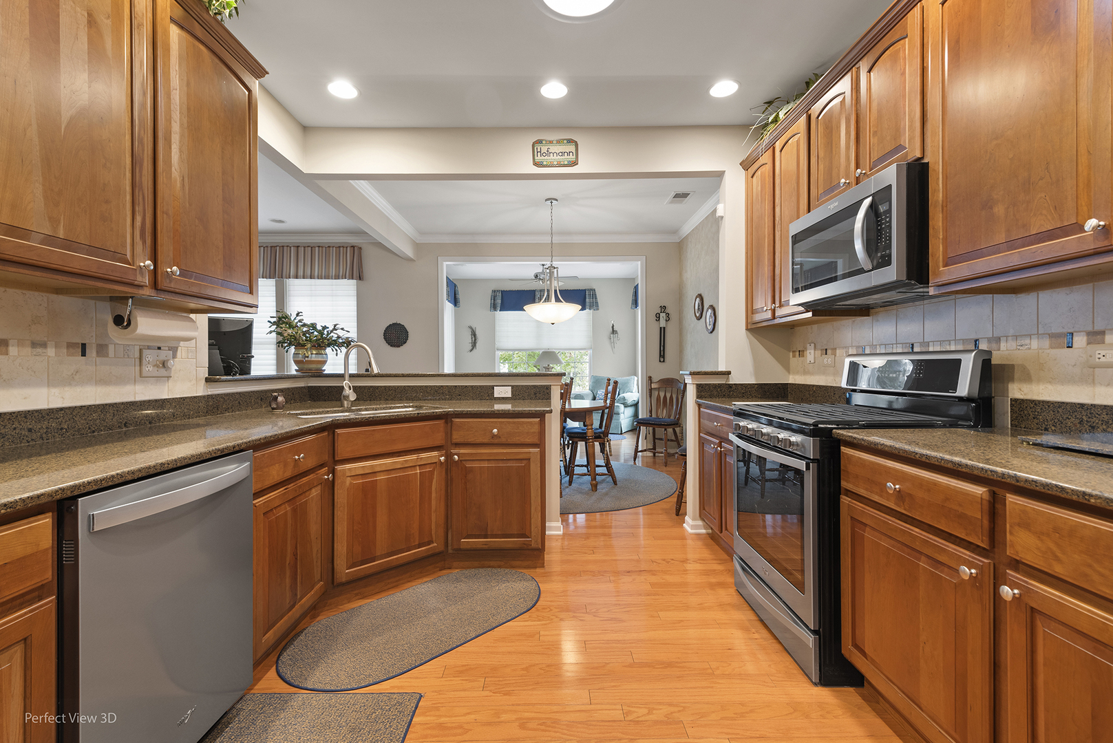 2468 Rolling Ridge Elgin, IL 60124 - Photo 4 of 29 a kitchen with stainless steel appliances granite countertop wooden cabinets a sink and a stove