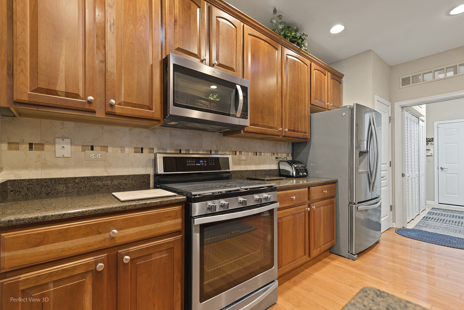 2468 Rolling Ridge Elgin, IL 60124 - Photo 6 of 29 a kitchen with stainless steel appliances granite countertop a refrigerator stove and microwave