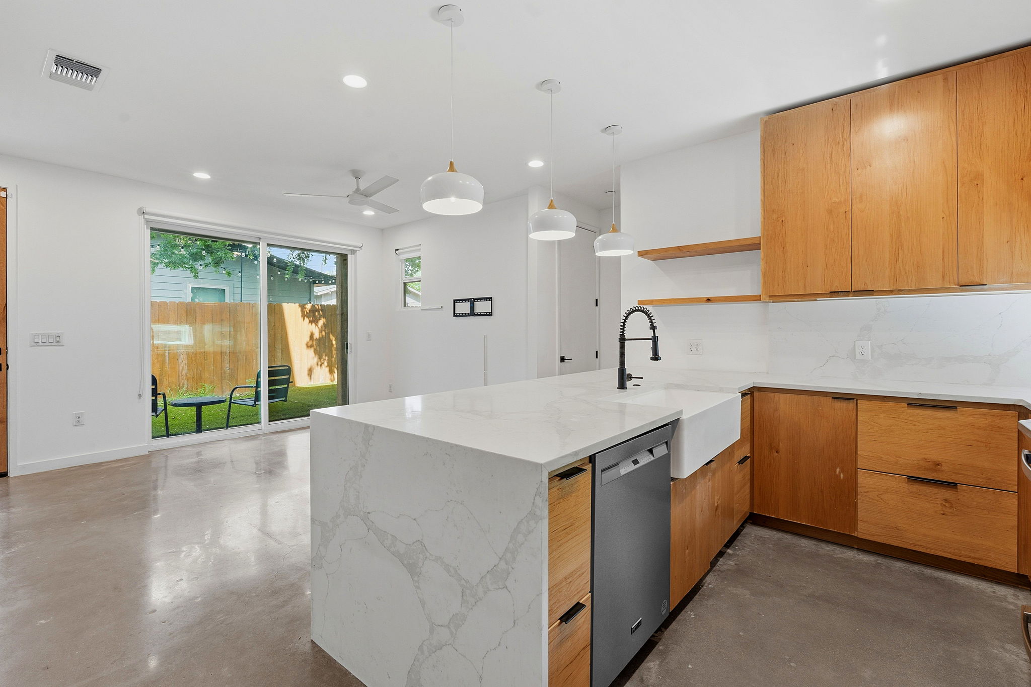 1707 Deloney Street, Unit 2 Austin, TX 78721 - Photo 12 of 26 A sleek modern kitchen with light wood cabinetry and a spacious island for culinary creation.