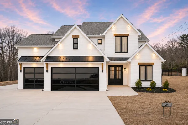 a view of a house with a yard and garage