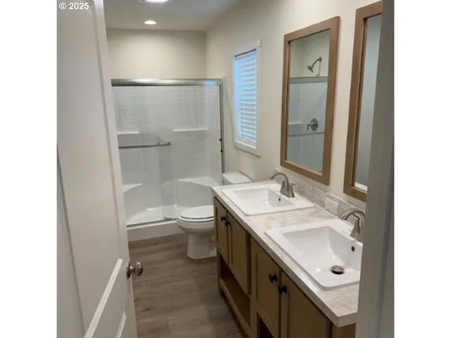a bathroom with a sink a toilet and shower