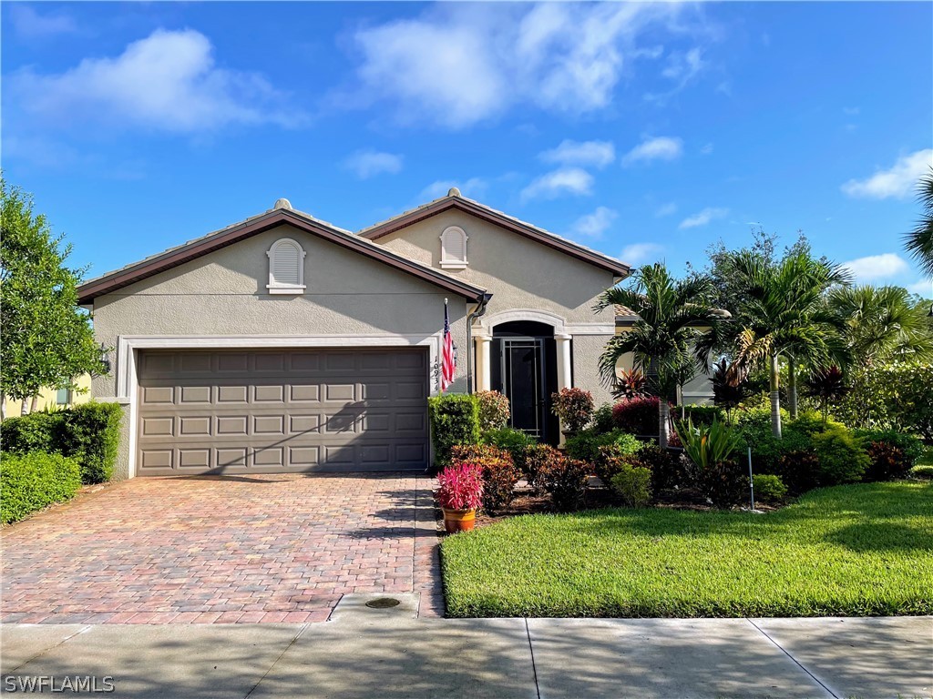 10934 Dennington Road Fort Myers, FL 33913 - Photo 1 of 15 a front view of a house with a yard and garage