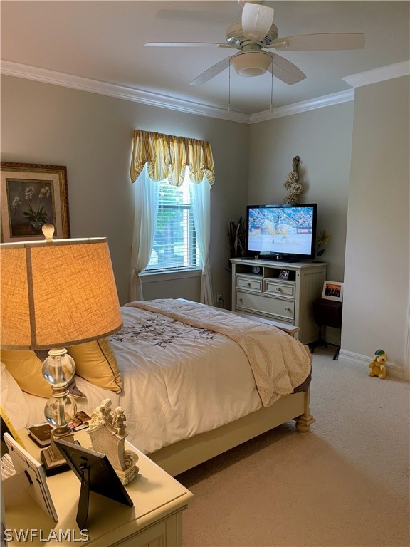 10934 Dennington Road Fort Myers, FL 33913 - Photo 12 of 15 a bedroom with a bed and a chandelier