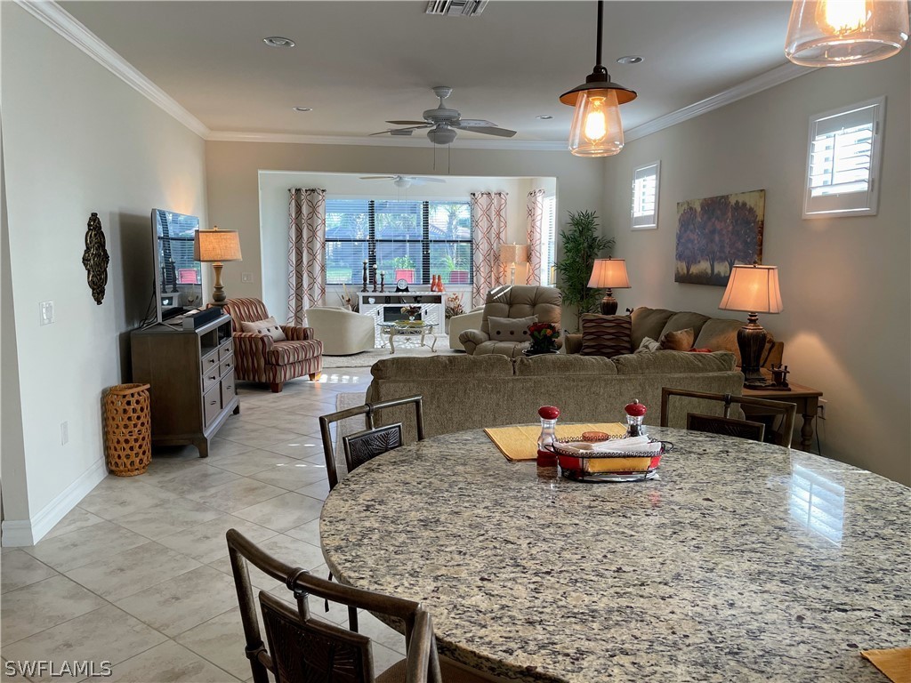 10934 Dennington Road Fort Myers, FL 33913 - Photo 2 of 15 a living room with furniture a chandelier and a flat screen tv
