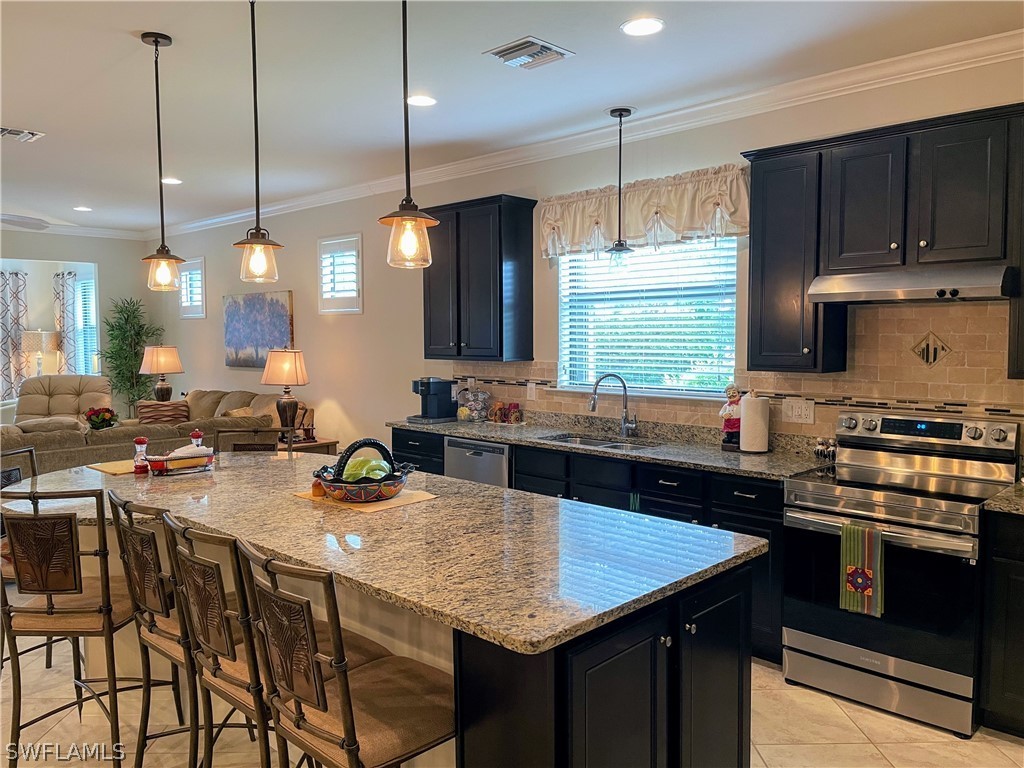 10934 Dennington Road Fort Myers, FL 33913 - Photo 10 of 15 a kitchen with sink stove and cabinets