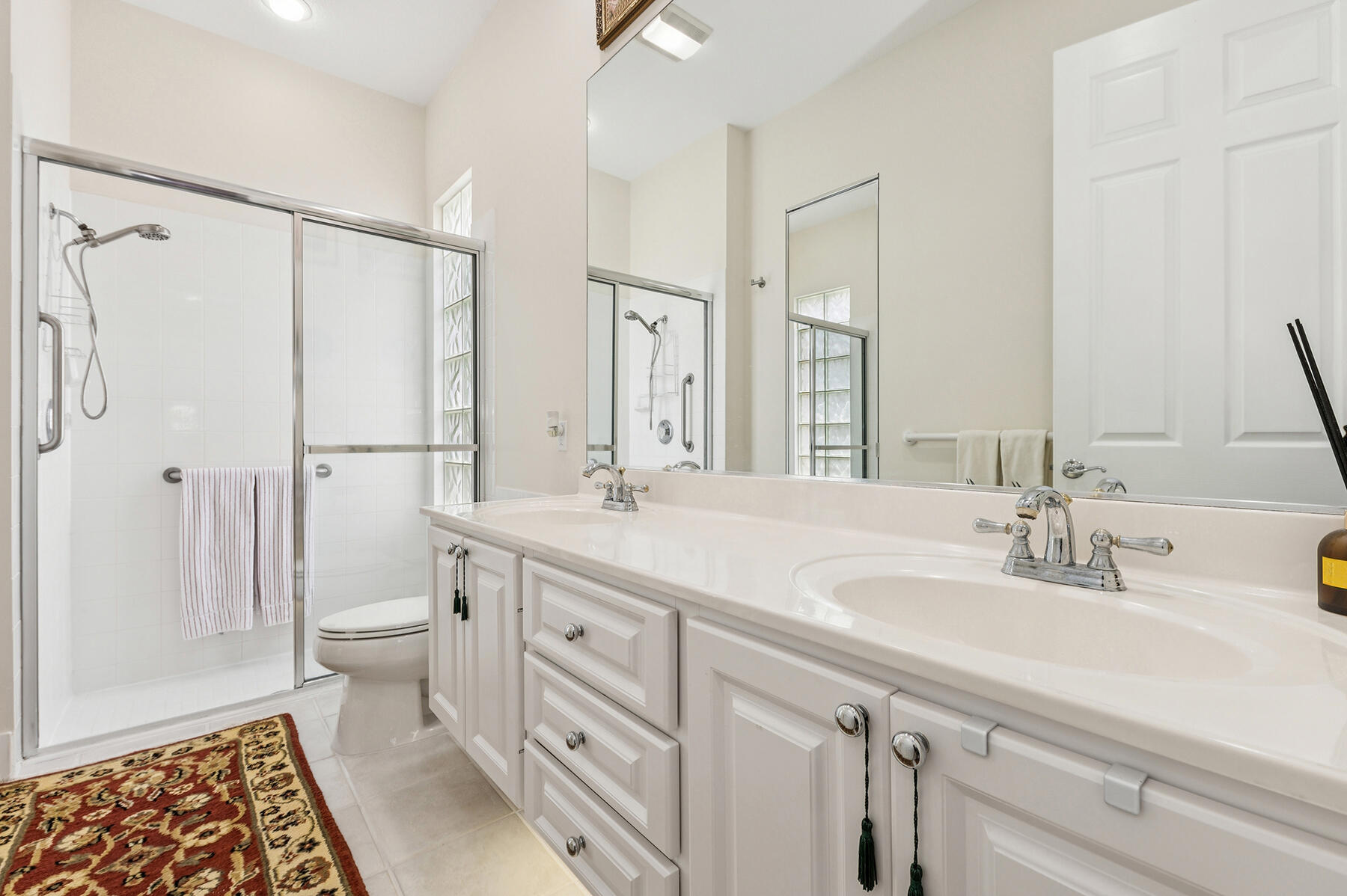 2613 James River Road West Palm Beach, FL 33411 - Photo 14 of 57 a bathroom with double vanity sink a mirror and a shower