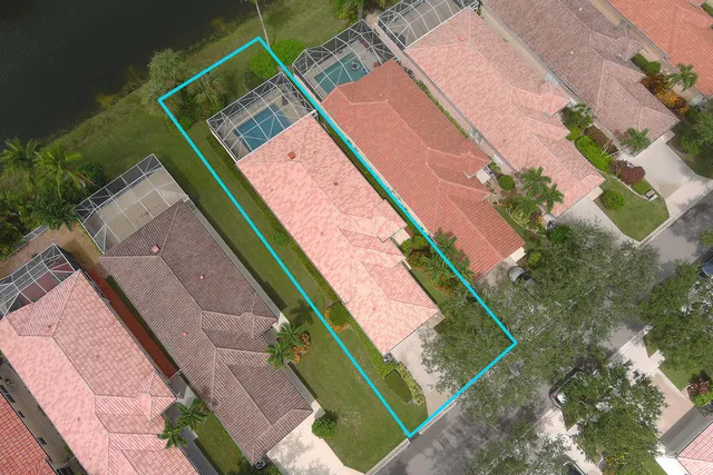 an aerial view of lake and residential houses with outdoor space