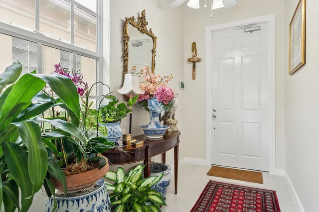 a room with stainless steel appliances kitchen island granite countertop furniture and a large window
