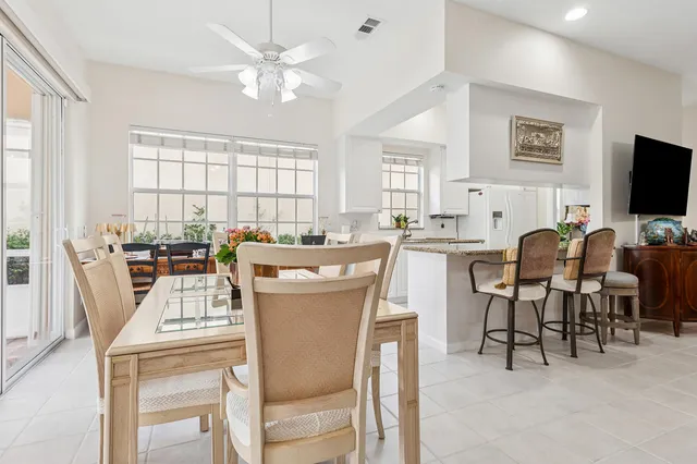 a large white kitchen with stainless steel appliances