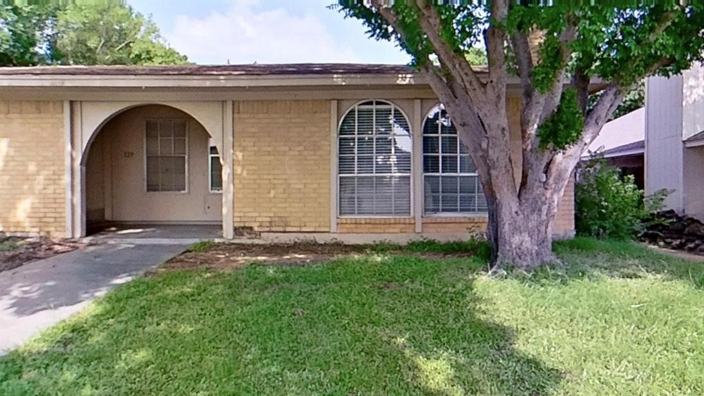 527 Crowley Road Arlington, TX 76012 - Photo 3 of 20 Brick exterior featuring an arched entryway and twin arched windows with louvered blinds