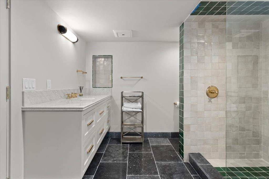 4259 Crestline Road Fort Worth, TX 76107 - Photo 21 of 40 a spacious bathroom with a double vanity sink a mirror and a shower