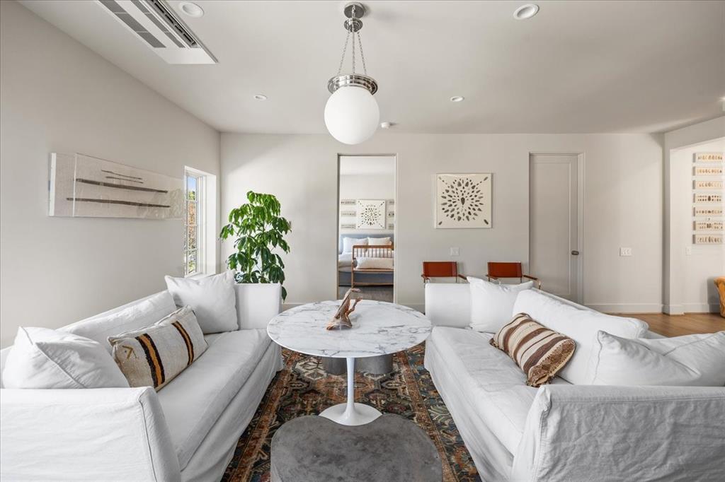 4259 Crestline Road Fort Worth, TX 76107 - Photo 33 of 40 a living room with furniture and a chandelier