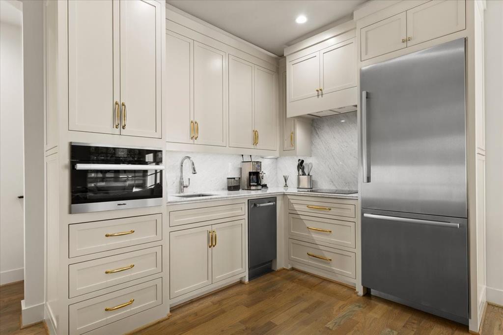 4259 Crestline Road Fort Worth, TX 76107 - Photo 34 of 40 a kitchen with white cabinets and stainless steel appliances