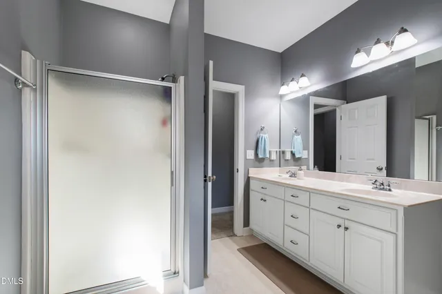 a bathroom with a double vanity sink and a mirror