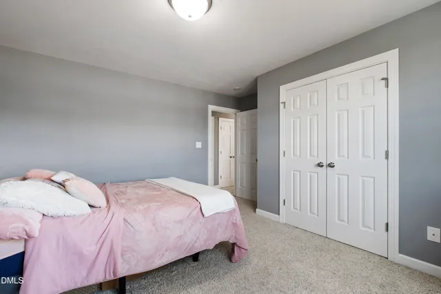 a bedroom with a bed and a closet