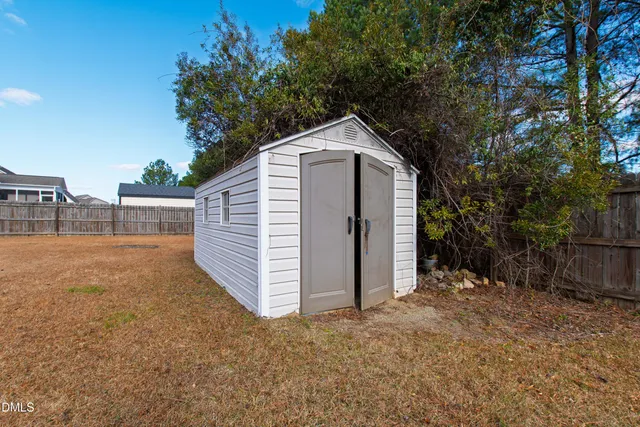 a view of a small house with a yard