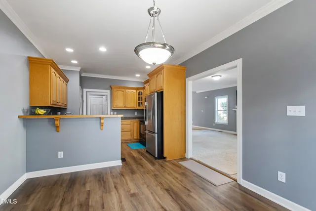 a view of a kitchen with a refrigerator and a stove