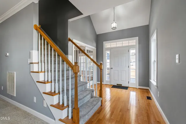 a view of an entryway with wooden floor and door